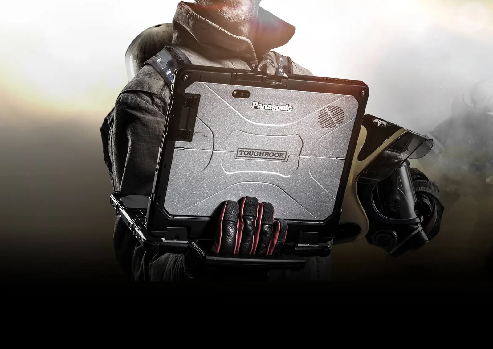Firefighter in turnout gear holding a Panasonic Toughbook